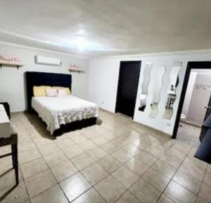 a bedroom with a bed and a display of shoes at Casa Morada in San Felipe