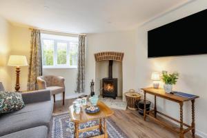 a living room with a couch and a fireplace at 2 Bed in Chideock oc-c36616 in Chideock