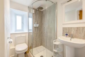 a bathroom with a shower and a toilet and a sink at 2 Bed in Chideock oc-c36616 in Chideock +15 photos