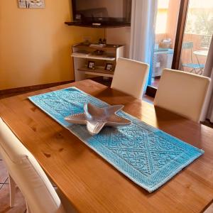 a dining room table with a starfish on the table at La Marina Apartment with Pool in Olbia