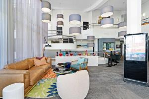 a living room with a couch and chairs at BEST WESTERN PLUS Apollo Hotel Newcastle in Newcastle