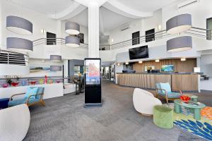a large lobby with chairs and a reception area at BEST WESTERN PLUS Apollo Hotel Newcastle in Newcastle