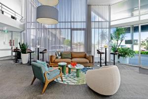 a living room with a couch and chairs at BEST WESTERN PLUS Apollo Hotel Newcastle in Newcastle