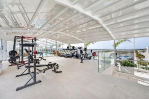 a gym with treadmills and ellipticals in a building at Riva Waterfront in Olhão