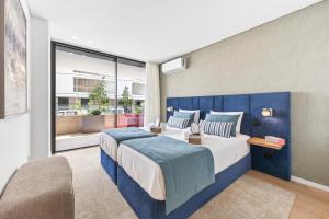 a bedroom with a large bed and a large window at Riva Waterfront in Olhão +68 photos