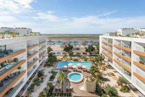 an aerial view of an apartment complex with a pool at Riva Waterfront in Olhão