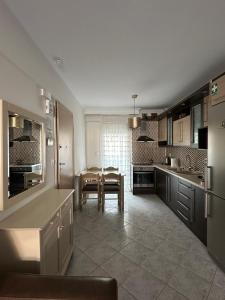 a kitchen with a table and a dining room at Paul House in Metamorfosi