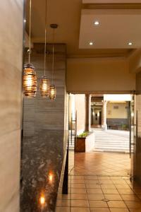 a lobby with pendant lights in a building at Hotel Hacienda del Sol in Tonalá