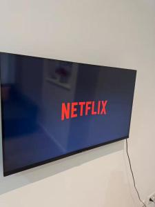 a monitor with the words netflix on it at Stylish 1BR Apartment with Sofa Bed in the Heart of Liège in Liège