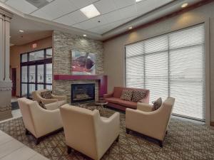 ein Wohnzimmer mit Sofa, Sesseln und Kamin in der Unterkunft DoubleTree by Hilton Bloomington in Bloomington