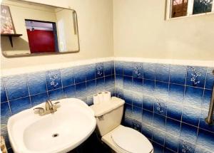 a bathroom with a white toilet and a sink at Casa Morada in San Felipe +21 photos