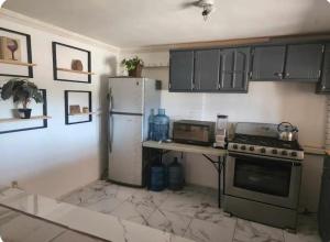 a kitchen with a refrigerator and a counter top at Casa Morada in San Felipe
