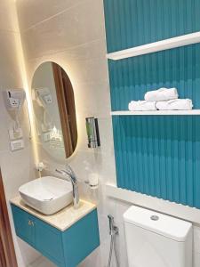 a bathroom with a sink and a mirror and a toilet at Atlantis Hotel in Cairo