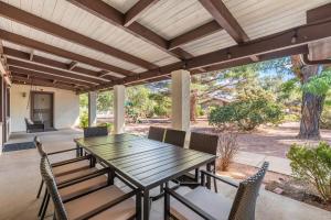 an outdoor patio with a wooden table and chairs at Sedona 2BR Near Trails & Shops in Sedona