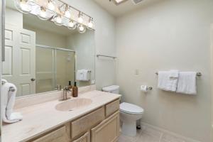 a bathroom with a sink and a toilet and a mirror at Sedona Spacious 2BR Desert Escape in Sedona +10 photos