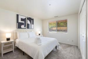 a white bedroom with a bed and a window at Sedona Spacious 2BR Desert Escape in Sedona