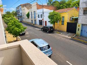 a car parked on the side of a street at La mansion caballero hostal in Asunción