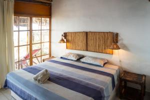 a bedroom with a bed with a backpack on it at kontiki in Máncora