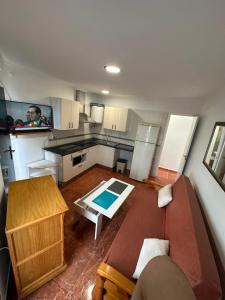 an overhead view of a kitchen with a couch and a table at Apartamento La Línea 3 in La Línea de la Concepción
