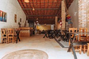 a dining room with tables and chairs in a room at Pousada Zayon Jeri in Jericoacoara