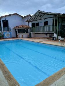 a swimming pool in front of a house at Hotel Mision Santa Barbara in Barichara
