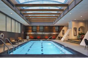 a swimming pool in a hotel lobby with a skylight at The Palmer House Hilton in Chicago