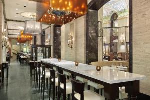 a bar in a restaurant with a row of stools at The Palmer House Hilton in Chicago +71 photos