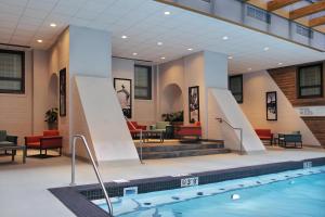 a pool in a hotel lobby with chairs and tables at The Palmer House Hilton in Chicago