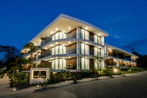 a large building with a sign in front of it at Mono Luxe Villas in Tamarindo