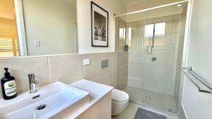 a bathroom with a sink and a shower and a toilet at Binshaw Main House in Glenlee Station +29 photos