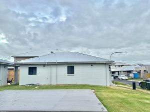 a white house with a driveway in front of it at Binshaw Main House in Glenlee Station