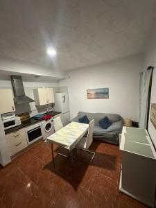 a small living room with a table and a couch at Apartamento La Línea 1 in La Línea de la Concepción