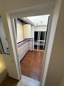 a view from the hallway of a room with a tile floor at Apartamento La Línea 1 in La Línea de la Concepción +4 photos