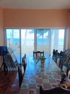 ein Esszimmer mit einem Tisch und Blick auf den Strand in der Unterkunft Seidy del Mar in Telchac