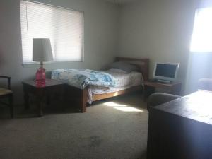 a bedroom with a bed and a desk with a computer at Comfy Room 2 in Overland Park