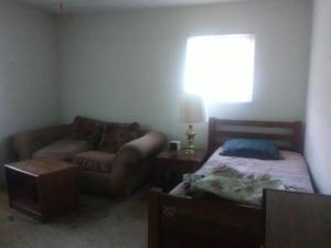 a bedroom with a couch and a bed and a window at Comfy Room 2 in Overland Park