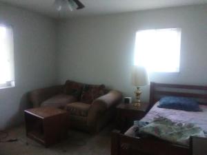 a living room with a couch and a bed at Comfy Room 2 in Overland Park