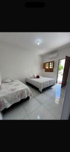 a bedroom with two beds and a window at Pousada Vale do Catimbau in Buíque +21 photos