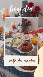 a table full of food with a cake on it at Pousada Vale do Catimbau in Buíque