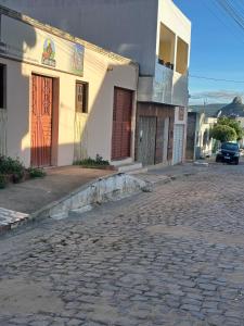 a cobblestone street in front of a building at Pousada Vale do Catimbau in Buíque