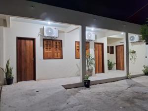 a building with a bunch of doors on it at Pousada Vale do Catimbau in Buíque