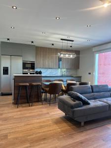 a living room with a couch and a table and a kitchen at Brisa de Sálvora in Ribeira
