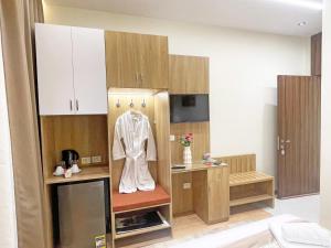 a kitchen with a robe hanging on the wall at Atlantis Hotel in Cairo