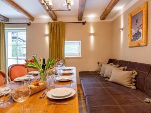 a dining room with a couch and a table at Biber Art Apartment 2 Small in Biberwier