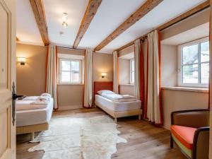 a room with two beds and two windows at Biber Art Apartment 2 Small in Biberwier