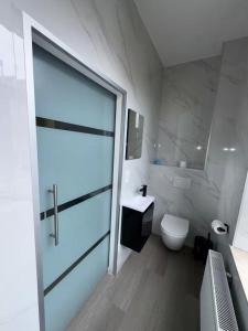a bathroom with a toilet and a sink at Stylish 1BR Apartment Close to City Center Liège in Liège