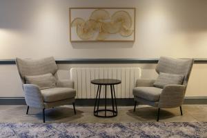 two chairs and a table in a waiting room at Hilton Cobham in Cobham