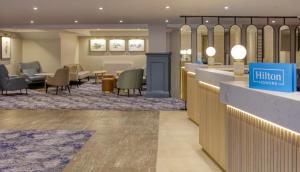 a lobby of a hotel with a waiting room at Hilton Cobham in Cobham