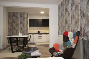 a kitchen and living room with a table and chairs at Stan na dan Moonlight Panonija in Inđija +18 photos