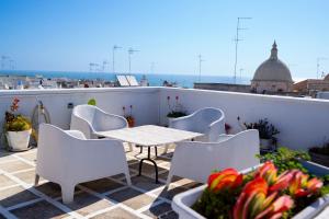 a table and chairs on the roof of a building at La Torre e il Mare - Room 3 by StHey in Monopoli